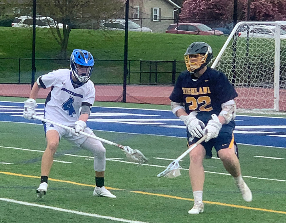 Wallkill’s Miguel Lopez closes in on Highland’s Dean Klotz in boys’ lacrosse on Friday.